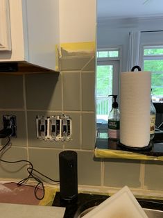 a kitchen counter with a roll of toilet paper on it