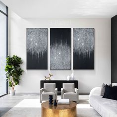 a living room with three paintings on the wall