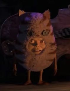 an animated cat with big eyes and a beard standing in front of a large guitar