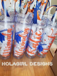 there are many cups with toothbrushes in them on the table and one is labeled nolagirl designs