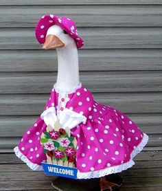 a duck wearing a pink polka dot dress and hat