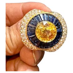 GIA Certified Approximately 10 Ct Natural Ceylon Yellow Sapphire , 6 ct Blue Baguettes sapphire & 3 ct Diamond Ring 18 Karat yellow gold , An estate piece GIA Report # 5222873665 Natural Corundum Sri Lanka Yellow Sapphire Heated Yellow sapphire round , Natural Corundum measurement 12.22 X 11.66 X 7.81 mm making it a sizable and impressive center stone. Center yellow sapphire is surrounded by lots of blue sapphire baguettes in shape . There are approximately 6 + ct of blue sapphire . last few row Blue Sapphire Diamond Ring, Blue Sapphire Diamond, Diamonds Ring, Sapphire Diamond Ring, No Heat, Yellow Sapphire, Sapphire Diamond, Solitaire Ring, Cocktail Rings