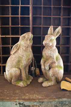 two stone rabbits sitting next to each other