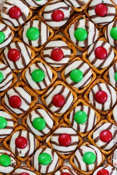 there are many pretzels with candy on the top one is white and green