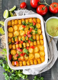 a casserole dish filled with tater tots and garnishes