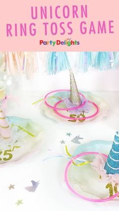 unicorn ring toss game with party delights on the table in pink and blue colors