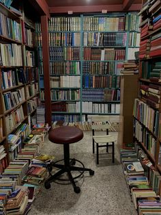 a room filled with lots of books and chairs