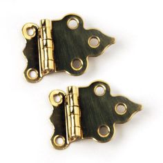 two brass plated metal hinges with holes