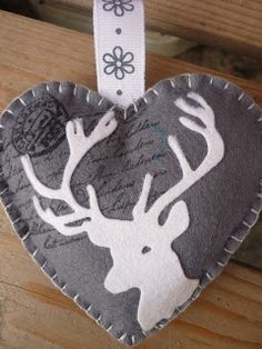 a heart shaped ornament with a deer head on it