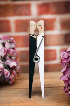 a pair of scissors that are next to some flowers