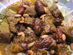 a plate with meat and nuts on it