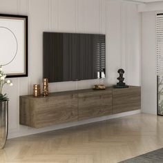 a living room filled with furniture and a flat screen tv on top of a wooden cabinet