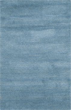 an area rug with blue tones on the top and bottom, in shades of light blue