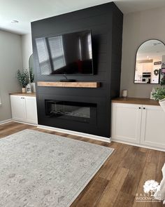 a large flat screen tv mounted to the side of a wall in a living room