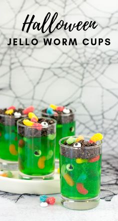 halloween jello worm cups on a plate with candy in the cup and sprinkles