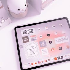 an ipad sitting on top of a white table next to a mouse and some boxes