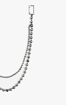 a long necklace with silver beads hanging from it's side