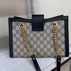 For a stylish, classy and luxurious look, this Gucci bag is the perfect choice. Sling this beauty on your shoulders and revel in the luxurious taste it brings. Gucci Monogram, Monogrammed Leather, Timeless Handbag, Gucci Black, Vuitton Bag, Diaper Backpack, Chain Shoulder Bag, Bags Designer Fashion, Exclusive Bag