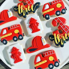 decorated cookies are arranged on a plate with firetrucks and hydrant decorations