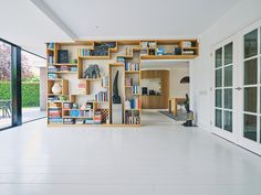 an open room with bookshelves and sliding glass doors