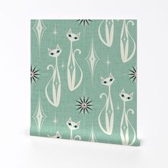 a green and white wallpaper with cats in the middle, stars and shapes on it