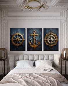 a bedroom with two paintings on the wall and an anchor, compass and ship wheel