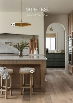 a kitchen with two stools and an island