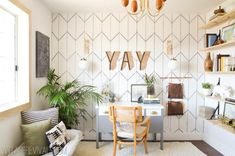 a room with a desk, chair and shelves on the wall that says yay