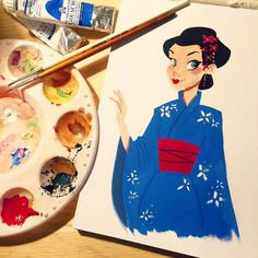 an artist's palette with paint and watercolors next to a drawing of a geisha