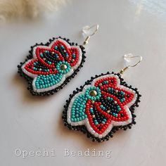 Native American beaded earrings ~ Beaded Earrings ~ Beaded floral ~ beadwork ~ earrings  -handmade -size 11 Czech beads, Czech cut beads, and Japanese beads -colors : Red, turquoise, ceylon white, black, and silver -buckskin leather backing  -silver plate hooks -Ojibwe made Native American Clothing, Beaded Earrings Native, Earrings Ideas, Beaded Earrings Diy