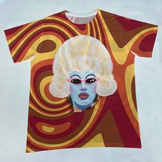 It’s your favorite drag queen on a premium comfy All Over Print T-Shirt officially licensed and exclusive from DragQueenMerch.com!**IMPORTANT: All-Over Print Tees are printed by sublimation in which the design is printed onto a white blank ready-made T-shirt. Please note that white streaks, smudges, or creasing will appear around the seams, especially around the shoulders, under the armpits, and around the collar of the shirt.Sizing on sublimated t-shirts run 1.5x smaller than a standard 100% Co Juno Birch, White Blank, How To Make Tshirts, Juno, White Hoodie, Ready Made, Printed Tees, White T, Black Hoodie