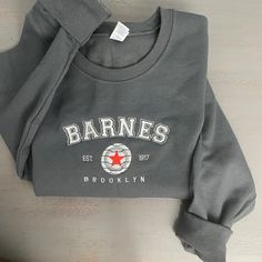 Barnes 1917 Embroidered Sweatshirt Celebrate timeless style and heritage with the Barnes 1917 Embroidered Sweatshirt. Featuring elegant embroidery that proudly showcases "Barnes 1917," this sweatshirt combines vintage-inspired design with modern comfort, making it a versatile staple for any wardrobe. Crafted from a premium cotton-poly blend, it offers a soft, cozy feel with durability that lasts. The relaxed fit and ribbed cuffs and hem provide a polished yet comfortable silhouette, perfect for Crew Sweatshirt With Embroidered Logo In French Terry, French Terry Crew Neck Sweatshirt With Embroidered Logo, Sporty Long Sleeve Sweatshirt With Custom Embroidery, Sporty Crew Neck Sweatshirt With Custom Embroidery, Varsity Sweatshirt With Custom Embroidery For Streetwear, Custom Embroidered Crew Neck Sweatshirt In Relaxed Fit, Custom Embroidery Relaxed Fit Crew Neck Sweatshirt, Varsity Crew Neck Sweatshirt With Custom Embroidery, Gray Crew Neck Sweatshirt With Embroidered Graphics