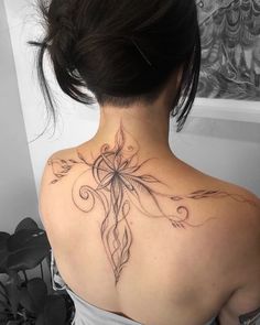 a woman with a tattoo on her back