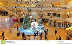 the inside of a shopping mall with christmas trees and decorations on display in the center