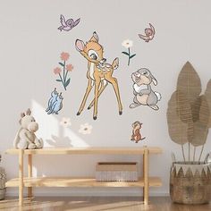 a wall with some animals on it and flowers in the background, next to a wooden bench