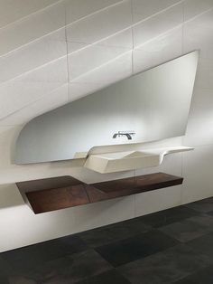 a bathroom sink sitting on top of a wooden shelf next to a wall mounted mirror