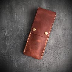 It is made of 100% top quality specially embroidered calf leather. Handmade leather pen holder fullgrain leather pen brush case with snap fastener cover and rivet detail. Pen art brush etc. A unique choice for your equipment with its slim design and soft leather texture. Dimensions Height: 7,87 inches (20cm) Width : 3,15 inches ( 8 cm) Classic Leather Pencil Case For Personal Use, Classic Leather Pencil Case With Pen Holders, Leather Brown Pencil Case With Pen Holders, Brown Leather Pencil Case With Pen Holders, Brown Leather Pencil Case Gift, Leather Rectangular Pencil Case For Gift, Leather Rectangular Pencil Case With Pen Holders, Leather Rectangular Pencil Case As Gift, Leather Pen Holder