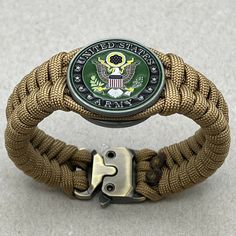 an army paracorre bracelet with the us marine seal emblem on it's clasp