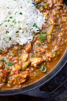 a pan filled with rice, beans and meat