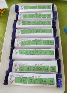 chocolate bar wrappers sitting on top of a white tray with candy bars in them