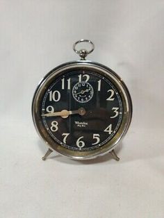 an alarm clock sitting on top of a white table