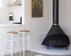 a kitchen with a stove and stools in it