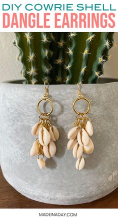 DIY Dangle Cowrie Shell Earrings, cowrie shell jewelry, diy earrings, shell earrings, how to make shell earrings, cowrie jewelry, dangle earrings, drop earrings, gold shell earrings, cowrie shell hoop earrings #cowrie #cowrieshell #jewelry #earrings #diyjewelry #shell #shellearings #diyfashion #fashion Cowrie Jewelry, Seashell Jewelry Diy, Cowrie Shell Earrings, Hoop Earrings Diy, Cowrie Shell Jewelry, Shell Jewellery, Gold Ideas, Diy Jewelry Earrings, Ear Crawlers