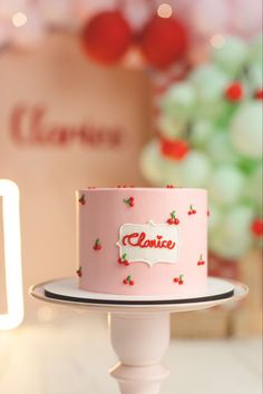 a pink cake sitting on top of a white plate