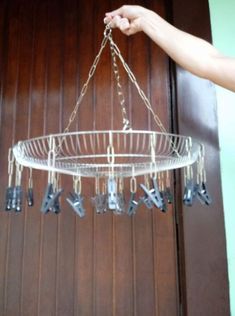 a chandelier hanging from a wooden door with keys in the bottom tier and chains on each end