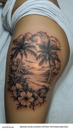 a woman's thigh with flowers and palm trees on the beach in front of her