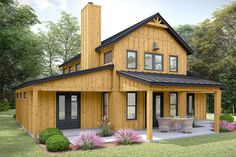 a large wooden house sitting on top of a lush green field