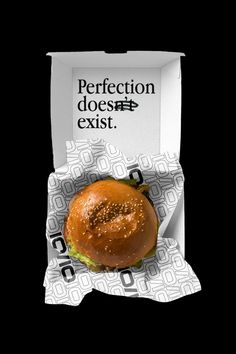 a sandwich in a box with the words perfectionion doesn't exist