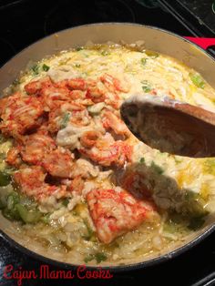 a skillet with shrimp and rice cooking on the stove