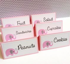 four pink place cards with elephants on them and words that read fruit sandwiches, cupcakes, cookies